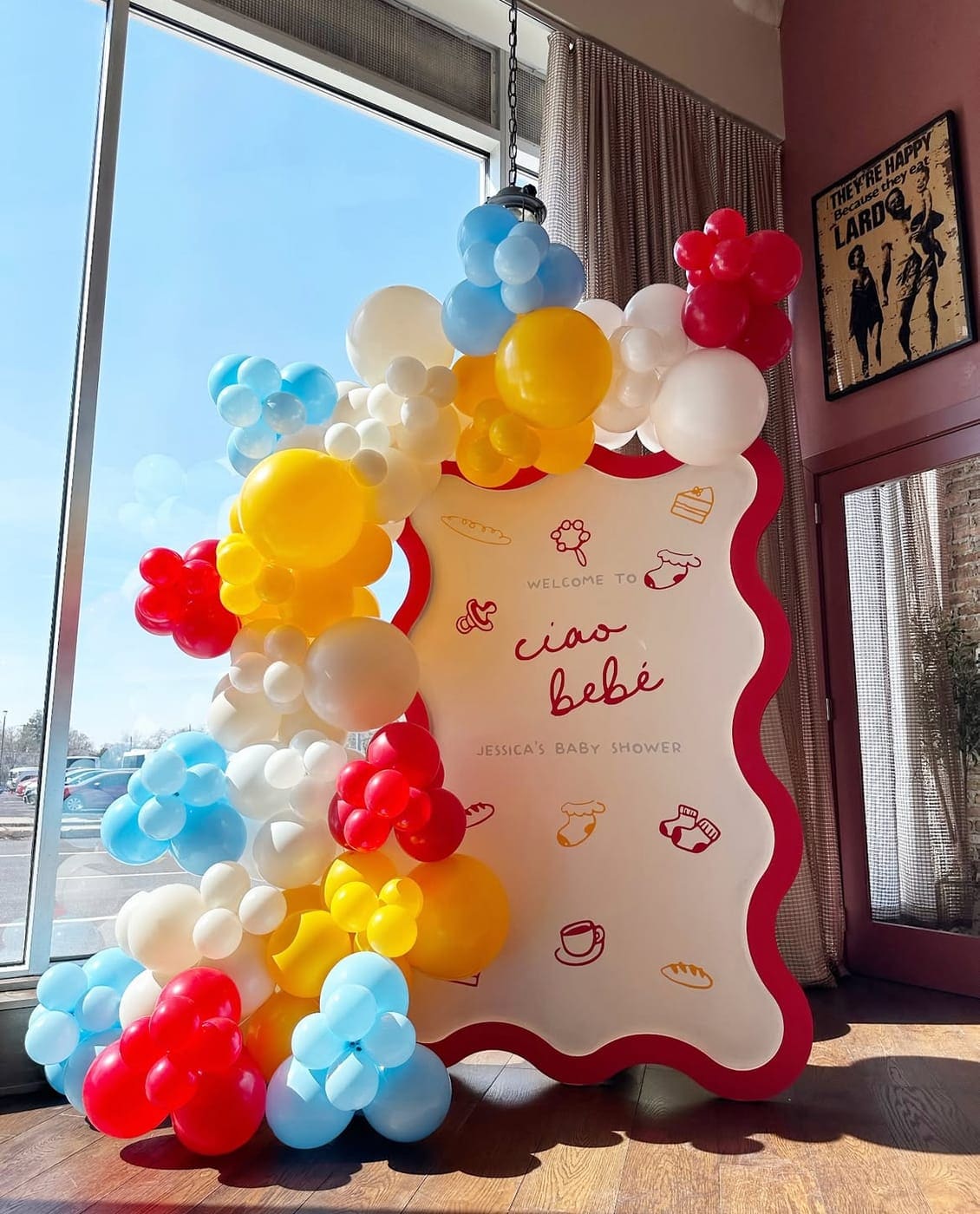 Baby shower balloon arch backdrop rental Chicago — Ciao Bébé wavy sign with colorful balloon garland