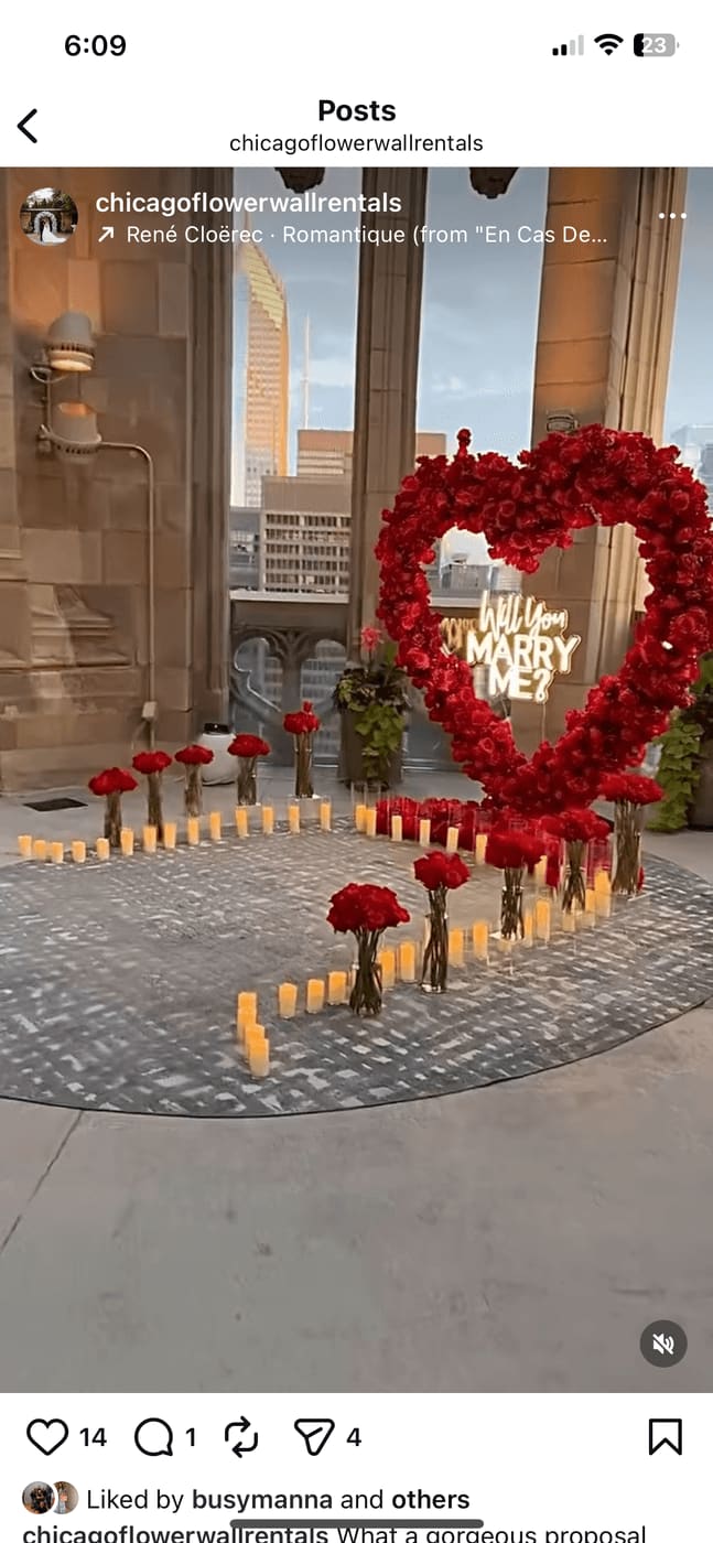Chicago rooftop proposal decor — red rose heart arch with Will You Marry Me neon sign and candlelit aisle