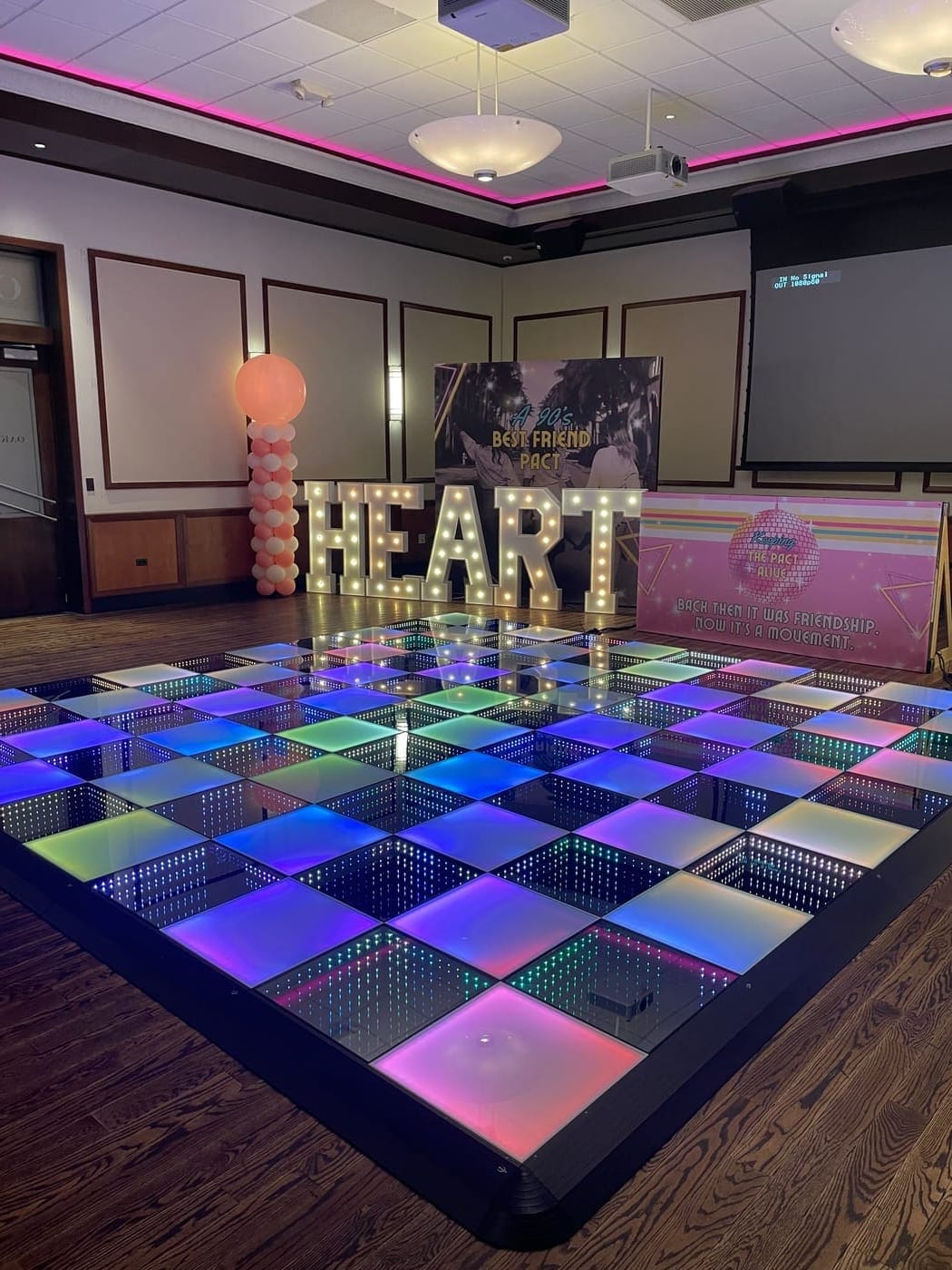 LED dance floor rental Chicago — illuminated infinity dance floor with HEART marquee letters event decor